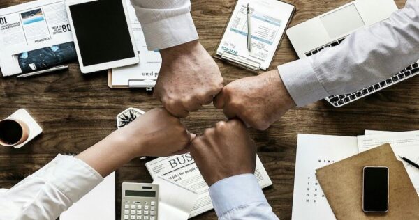 Working-professionals-fist-bumping_GoDaddy_6.27.23A1